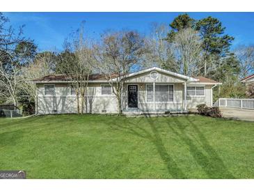 Charming single-story home with a well-manicured lawn and inviting front entrance at 4385 Midway Rd, Douglasville, GA 30134