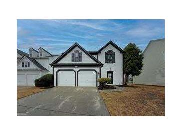 Charming home with a two-car garage and well-manicured lawn, offering great curb appeal at 2587 Alvecot Cir, Atlanta, GA 30339