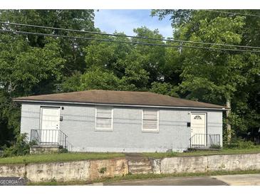 Two unit home featuring a brick facade, offering classic charm and potential at 1419 Cleveland Ave, Atlanta, GA 30344