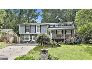 Charming home with stone accents, a front porch, and manicured lawn at 9138 Sunset Dr, Jonesboro, GA 30238