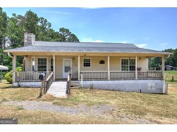 Charming ranch-style home featuring a covered front porch, and a well-maintained lawn at 668 Spring Place Ne Rd, White, GA 30184
