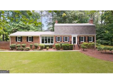 Charming brick home with manicured lawn and mature trees offering great curb appeal at 2179 Mountclaire Ct, Stone Mountain, GA 30087
