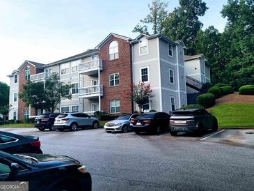 Charming apartment complex featuring brick accents, well-maintained landscaping, and ample parking spaces at 1392 Orchard Park Dr, Stone Mountain, GA 30083