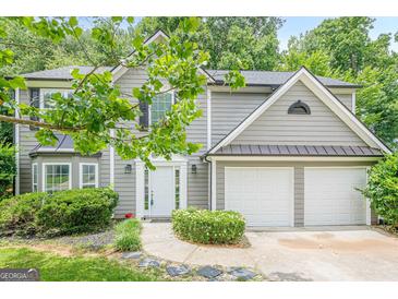 Charming two-story home with a well-manicured lawn and attached two-car garage at 4959 Abbotts Glen Nw Trl, Acworth, GA 30101