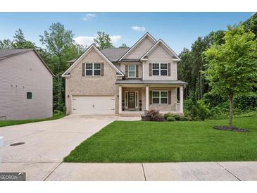Charming two-story home with brick and siding, a well-manicured lawn, and an attached two-car garage at 5662 Valley Loop, Fairburn, GA 30213