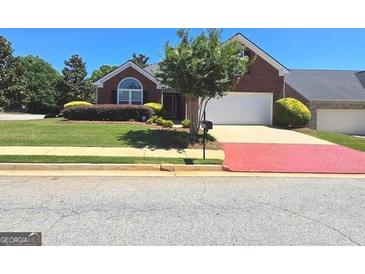 Charming brick home with a well-manicured lawn and inviting curb appeal at 1601 Celestial Ct, Mcdonough, GA 30253