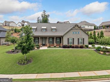 Charming one-story home with well-manicured lawn and stone accents create an inviting curb appeal at 406 Horizon Trl, Canton, GA 30114