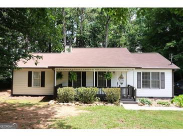 Charming single-story home featuring a covered front porch and well-maintained landscaping at 85 Pine Haven Dr, Carrollton, GA 30116
