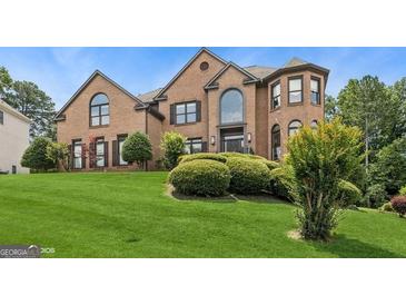 Attractive brick home with manicured lawn and mature landscaping at 3835 Hickory Branch Trl, Suwanee, GA 30024