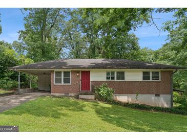 Charming single-story brick home with a red front door, covered parking, and a well-maintained lawn at 4653 Ridgewood Dr, Forest Park, GA 30297