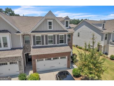 Beautiful two story home with a two car garage, brick and siding, shuttered windows and well maintained landscaping at 2060 Lanier Harbor Pt, Buford, GA 30518