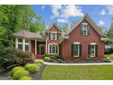 Charming brick home with manicured landscaping and classic architectural details at 770 Spalding Heights Dr, Atlanta, GA 30350