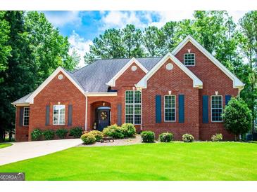 Charming brick home with a manicured lawn and mature trees offering classic curb appeal at 109 National Way, Carrollton, GA 30116