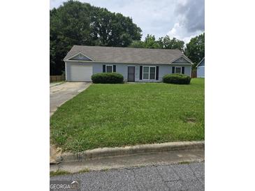 Charming single-story home features a well-manicured lawn, and an attached single car garage at 2985 Garnet Way, South Fulton, GA 30349