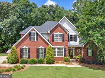 Charming two-story brick home with black shutters and a well-manicured lawn at 4147 Alayna Lee Cir, Mcdonough, GA 30252