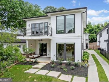 Modern two-story home showcasing a balcony, front porch, landscaped yard, and inviting curb appeal at 32 Walthall Ne St # A, Atlanta, GA 30307