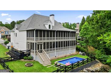 Stunning home with an outdoor pool and screened in back porch with a well maintained lawn and privacy at 6017 Chestatee Creek Nw Ct, Acworth, GA 30101