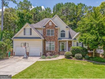 Charming two-story home with a stone facade and a well-manicured lawn at 119 Creekside Vw, Hiram, GA 30141