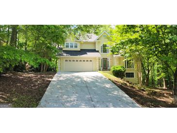 Charming two-story home featuring a well-manicured lawn, two car garage, and a welcoming front entrance at 3626 Lone Indian Trl, Marietta, GA 30066