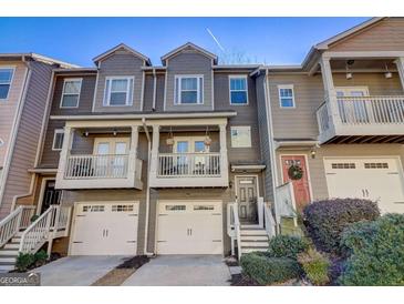 Charming townhome featuring a private balcony and an attached one-car garage at 1753 Liberty Pkwy, Atlanta, GA 30318
