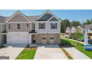 Charming two-story townhome with a single-car garage and well-maintained front lawn at 179 Stanchion Dr, Union City, GA 30291
