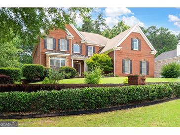 Brick two-story home featuring manicured lawn and dark shutters, enhancing curb appeal at 3045 Moss Stone Lane Sw Ln, Marietta, GA 30064