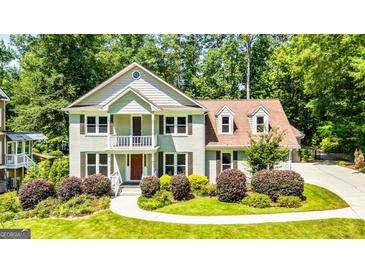Charming two-story home with manicured landscaping and a welcoming front porch, perfect for Southern charm at 115 Edgewater Way, Peachtree City, GA 30269