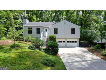 Charming two-story home with a two-car garage and inviting front yard at 7025 Stone Wood Nw Dr, Kennesaw, GA 30152