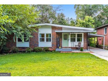 Charming brick home featuring a well-maintained lawn and inviting front porch at 222 Bishop Ne Dr, Marietta, GA 30060