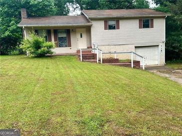Charming two-story home with a well-maintained front yard and quaint architectural details at 718 Hardy Way, Hiram, GA 30141