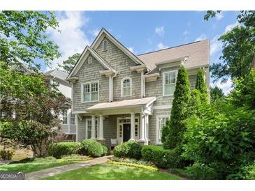 Charming two-story home with gray wood shingle siding, manicured landscaping and inviting front porch at 785 Wilson Nw Rd, Atlanta, GA 30318
