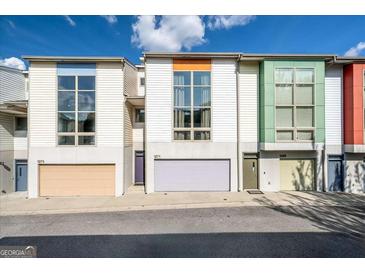 Modern townhomes featuring colorful accents and large windows for natural light at 1271 Mackintosh Nw Park # 30, Atlanta, GA 30318