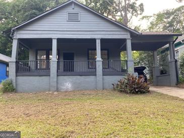 Charming bungalow style house featuring a covered front porch and a gray painted exterior at 1053 Metropolitan Parkway Southwest Sw Pkwy, Atlanta, GA 30310