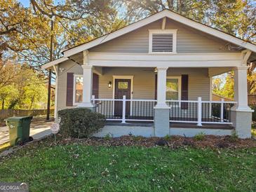 Charming home with a covered front porch, white columns, and a well-maintained lawn in a desirable neighborhood at 2148 M L King Jr Sw Dr, Atlanta, GA 30310