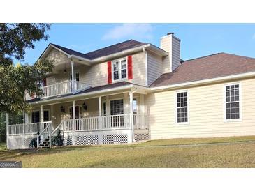 Charming two-story home with a welcoming front porch and a second-story balcony at 4335 Commodore Rd, Powder Springs, GA 30127