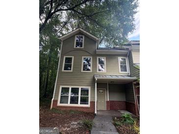 Charming two-story home with green siding and a welcoming front porch at 101 Dancing Fox Rd, Decatur, GA 30032