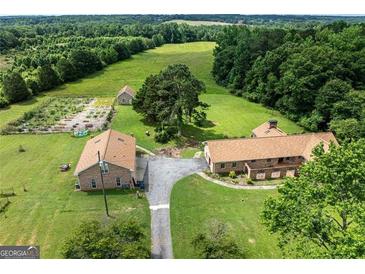 Stunning aerial view of country estate with lush green fields, brick homes and serene landscape at 1502 Campground, Mcdonough, GA 30252