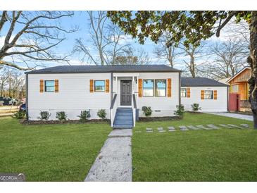 Charming single-story home with new exterior paint, dark roof and shutters, and a manicured lawn at 1092 Donnelly Sw Ave, Atlanta, GA 30310
