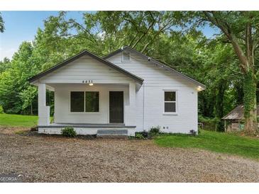 Charming single-story home featuring a welcoming porch and a freshly painted exterior at 4451 Flat Shoals, Decatur, GA 30034