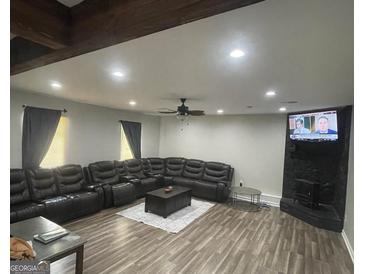 Spacious living room features hardwood floors, recessed lighting, and a modern ceiling fan at 176 Avalon Way, Riverdale, GA 30274