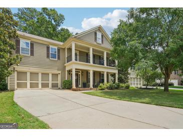 Charming two-story home features a welcoming front porch and attached two-car garage at 826 Richmond Cir, Peachtree City, GA 30269