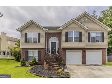 Charming two-story home featuring brick and siding exterior with a well-manicured front yard at 1006 Eagle Vw, Lawrenceville, GA 30044