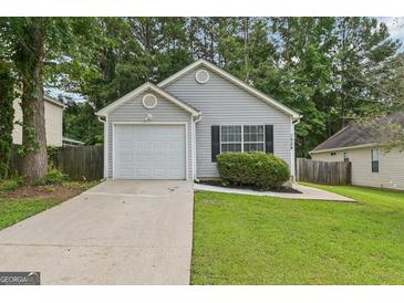 Charming single Gathering home with a well-maintained lawn and attached garage at 1528 Wembley Dr, Douglasville, GA 30134