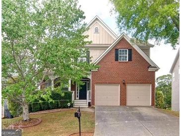 Two-story home with brick and siding, mature landscaping, and a two-car attached garage at 4518 Columbus Cir, Acworth, GA 30101