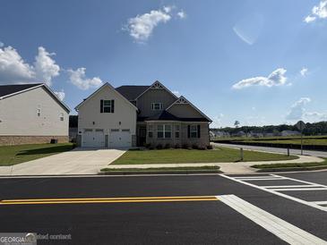 Charming two-story home with a two-car garage and well-maintained front yard, offering great curb appeal at 13709 Whitman Ln, Covington, GA 30014