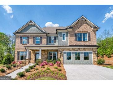 Charming two-story home with brick and siding exterior, landscaped yard, and inviting front porch at 313 Westfall Ter # 225A, Loganville, GA 30052