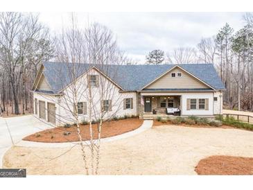 Charming single-Gathering home featuring a landscaped yard, attached garage, and inviting front porch perfect for relaxing at 150 Seals Rd, Dallas, GA 30157