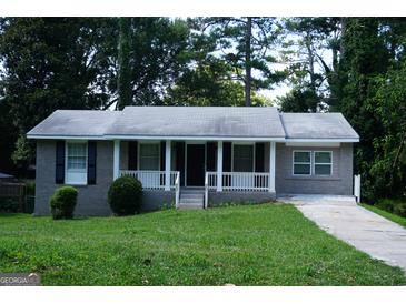 Charming one-story home with a well-maintained lawn and a welcoming front porch, ideal for relaxing outdoors at 39 Mcferrin Cir, Riverdale, GA 30274