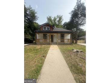 Charming single-story home with a welcoming front porch and mature trees at 1551 Broad Ne St, Conyers, GA 30012