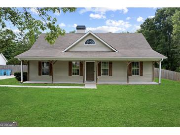 Charming single-story home with a welcoming front porch and manicured lawn at 312 Cattlemans Cir, Mcdonough, GA 30252